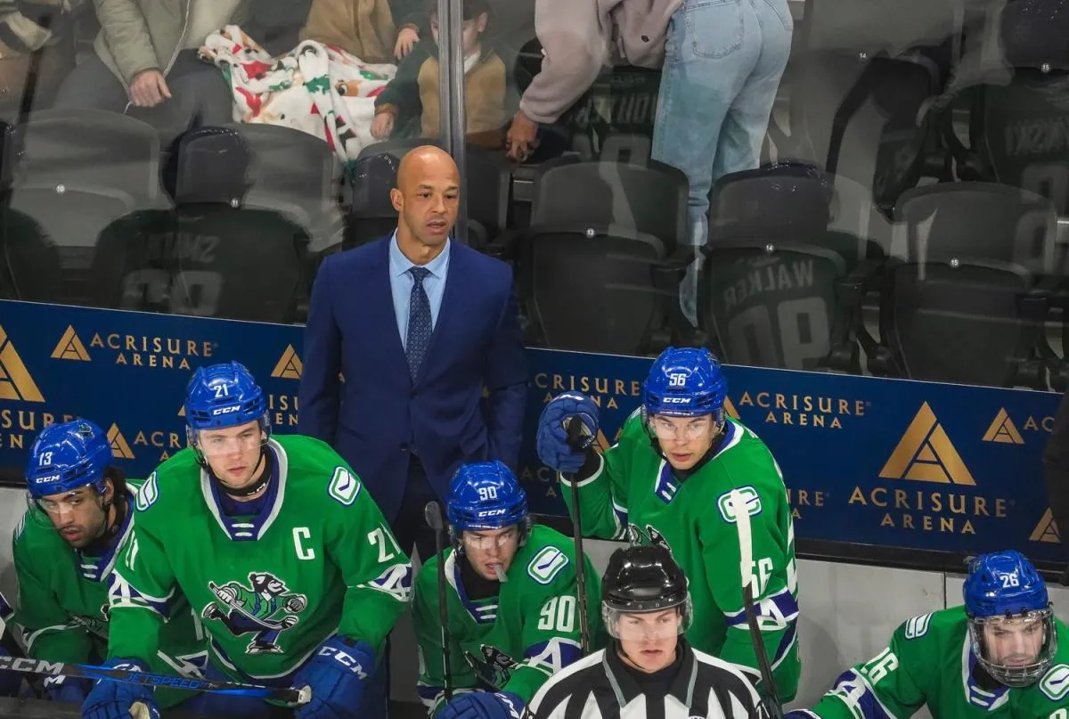 Abbotsford head coach Manny Malhotra watches his team from the bench during the first period of their game at Acrisure Arena in Palm Desert, Calif., Wednesday, Jan. 29, 2025.