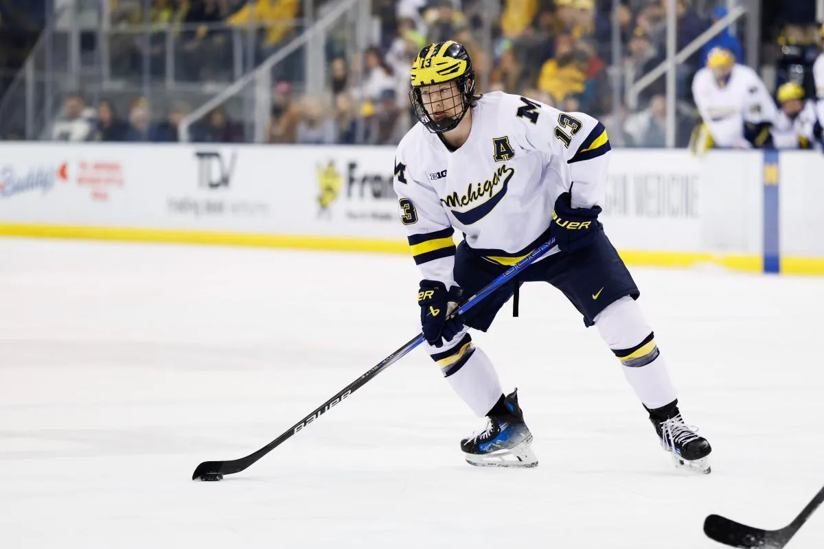 Michigan Wolverines forward T.J. Hughes (13) skates with the puck against Penn State during a Big Ten Tournament quarter final game at Yost Arena.
