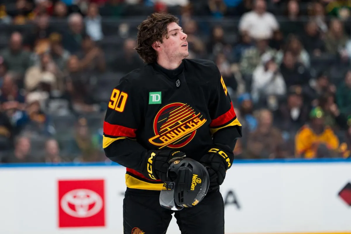 Vancouver Canucks defenseman Victor Mancini (90) puts his helmet back on after a scrum against the Florida Panthers in the first period at Rogers Arena.