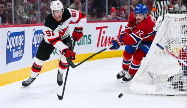 New Jersey Devils center Dawson Mercer (91) plays the puck against Montreal Canadiens defenseman Arber Xhekaj (72) during the second period at Bell Centre.