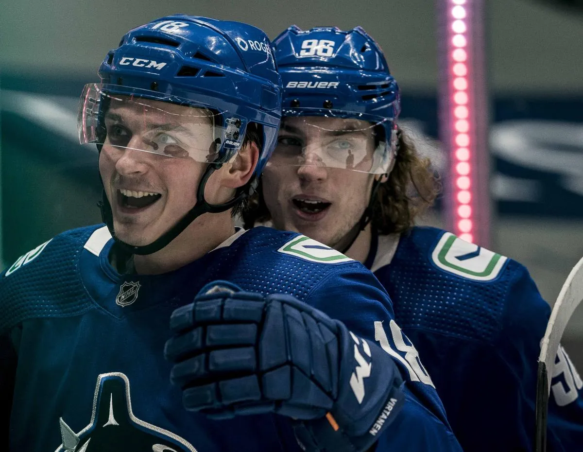 Vancouver Canucks forward Adam Gaudette (96) and forward Jake Virtanen (18) celebrate Virtanen s goal against the Toronto Maple Leafs in the second period at Rogers Arena.