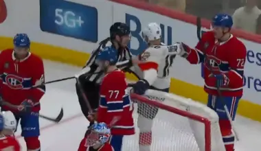 Photo of Arber Xhekaj defending Jakub Dobes from A.J. Greer.