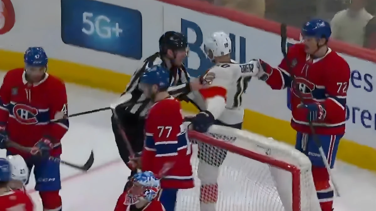 Photo of Arber Xhekaj defending Jakub Dobes from A.J. Greer.