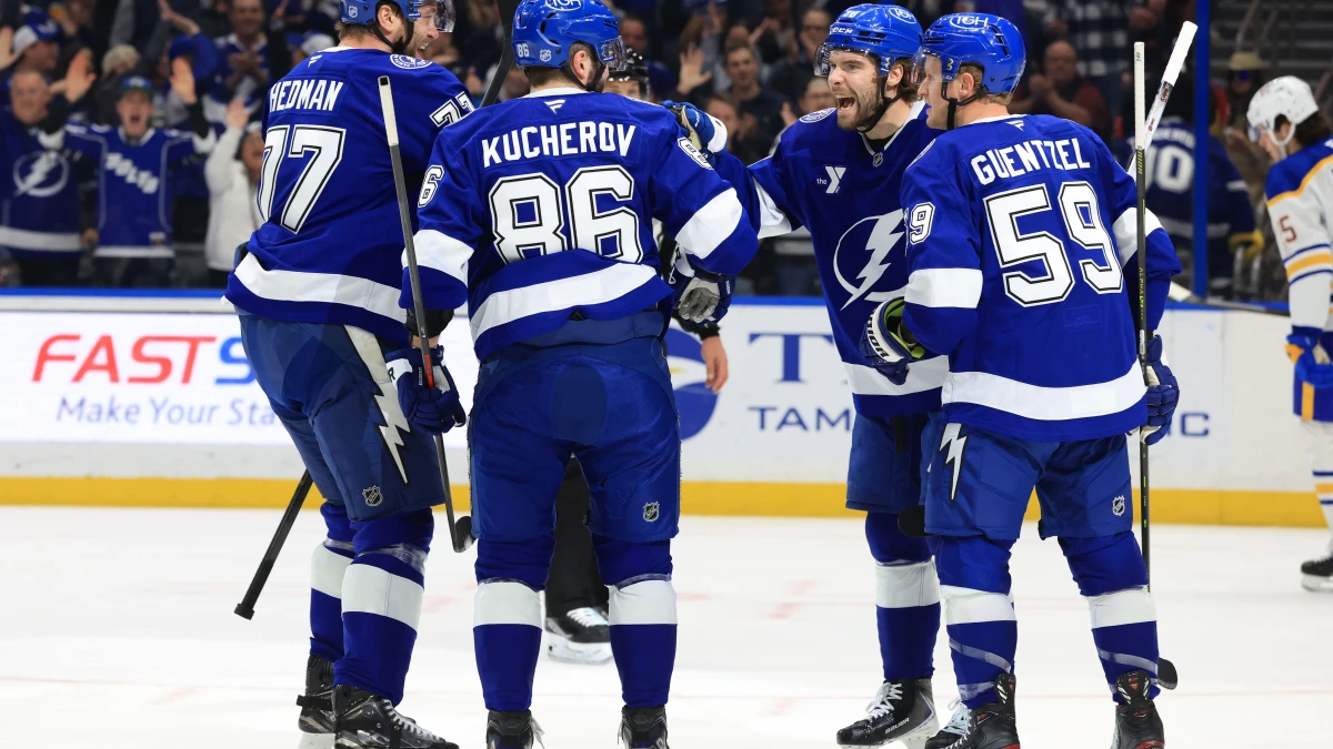 Tampa Bay Lightning right wing Nikita Kucherov (86) is congratulated by left wing Brandon Hagel (38), defenseman Victor Hedman (77) and center Jake Guentzel (59) after he scored a goal against the Buffalo Sabres during the first period at Benchmark International Arena.