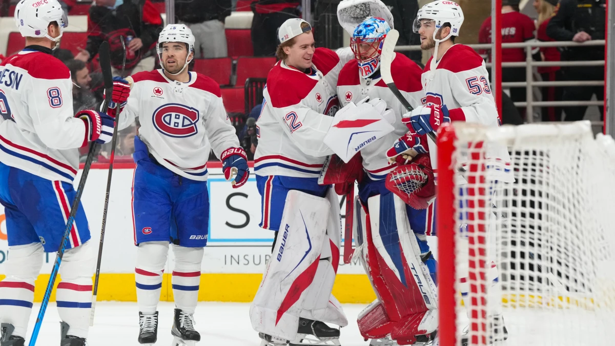 Montreal Canadiens goaltender Jakub Dobes (75) is congratulated by goaltender Jacob Fowler (32), defenseman Noah Dobson (53) and center Alex Newhook (15) after their victory against the Carolina Hurricanes at Lenovo Center.