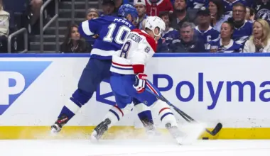 Tampa Bay Lightning forward Corey Perry (10) and Montreal Canadiens defenseman Mike Matheson (8) battle for the puck during the first period in game one of the first round of the 2026 Stanley Cup Playoffs at Benchmark International Arena.