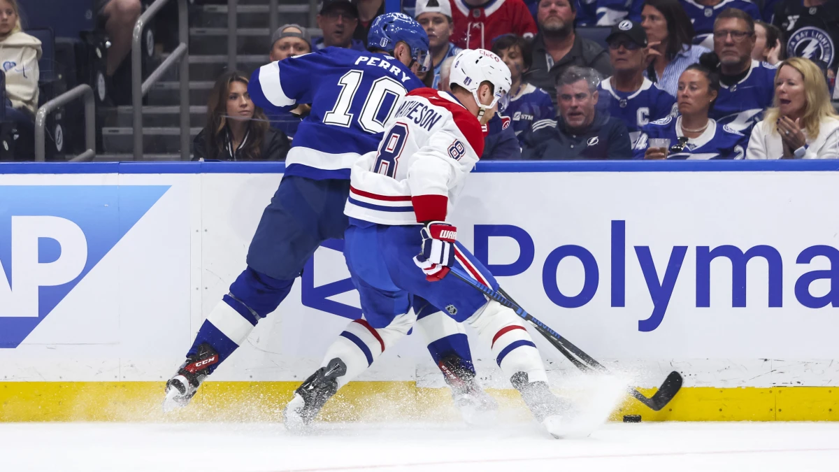 Tampa Bay Lightning forward Corey Perry (10) and Montreal Canadiens defenseman Mike Matheson (8) battle for the puck during the first period in game one of the first round of the 2026 Stanley Cup Playoffs at Benchmark International Arena.