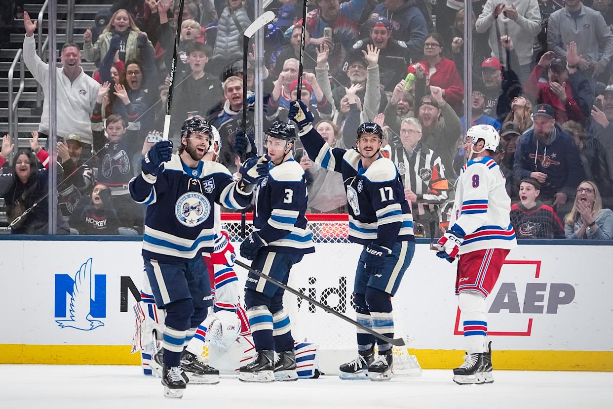 Columbus Blue Jackets center Adam Fantilli (19) reacts beside center Charlie Coyle (3) and left wing Mason Marchment (17) after scoring a goal during the NHL game against the New York Rangers at Nationwide Arena in Columbus on March 19, 2026. The Blue Jackets won 6-3.
