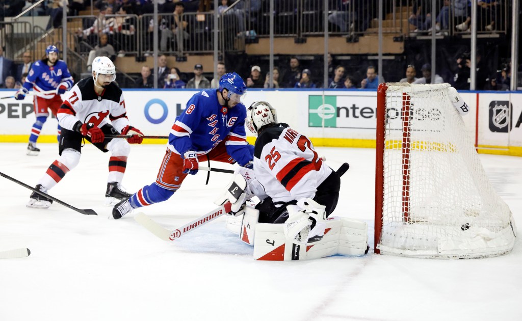 New York Rangers player J.T. Miller #8 scores a goal past New Jersey Devils goaltender Jacob Markstrom #25.