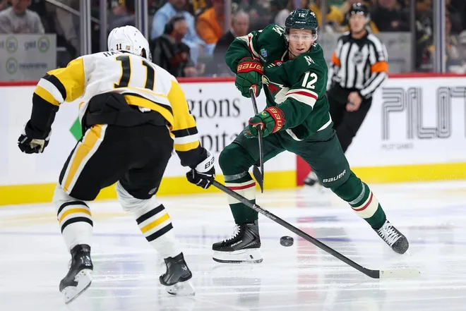 Oct 30, 2025; Saint Paul, Minnesota, USA; Minnesota Wild left wing Matt Boldy (12) shoots as Pittsburgh Penguins center Filip Hallander (11) defends during the second period at Grand Casino Arena.