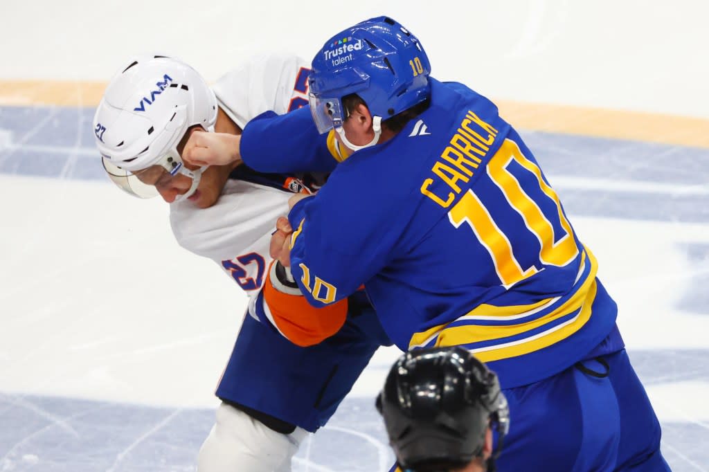 Anders Lee (27) and Sam Carrick (10) fight during the third period of the Islanders’ road loss to the Sabres. AP
