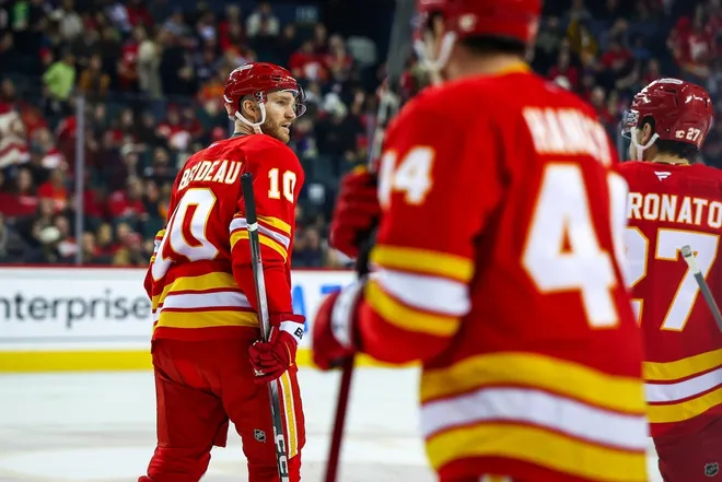 Jan 25, 2026; Calgary, Alberta, CAN; Calgary Flames left wing Jonathan Huberdeau (10) celebrates his goal with teammates against the Anaheim Ducks during the first period at Scotiabank Saddledome.