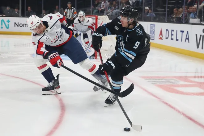 Mar 26, 2026; Salt Lake City, Utah, USA; Utah Mammoth right wing Clayton Keller (9) makes a pass against Washington Capitals defenseman Martin Fehérváry (42) during the third period at Delta Center.