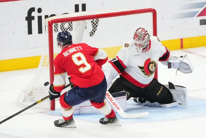 Mar 31, 2026; Sunrise, Florida, USA; Florida Panthers center Sam Bennett (9) tips the puck wide as Ottawa Senators goaltender James Reimer (47) looks on during the third period at Amerant Bank Arena.