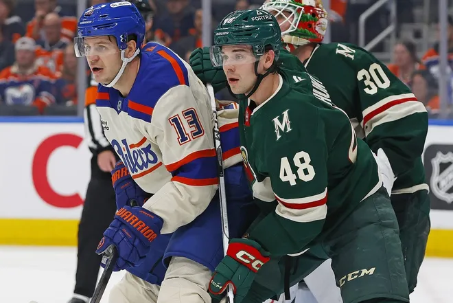 Jan 31, 2026; Edmonton, Alberta, CAN; Edmonton Oilers forward Mattias Janmark (13) and Minnesota Wild defensemen Daemon Hunt (48) battle for position during the third period at Rogers Place.