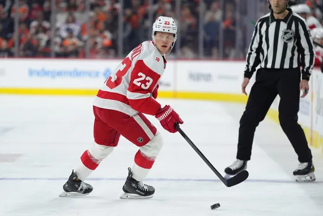 Apr 2, 2026; Philadelphia, Pennsylvania, USA; Detroit Red Wings left wing Lucas Raymond (23) controls the puck against the Philadelphia Flyers in the first period at Xfinity Mobile Arena.