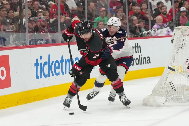 Apr 2, 2026; Raleigh, North Carolina, USA; Carolina Hurricanes left wing William Carrier (28) skates with the puck against Columbus Blue Jackets defenseman Zach Werenski (8) during the first period at Lenovo Center.