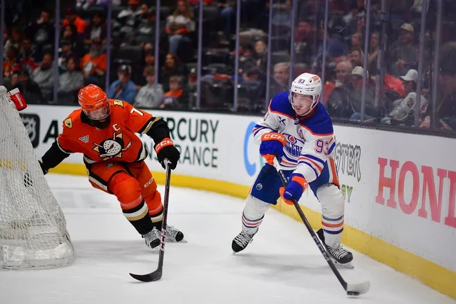 Apr 7, 2025; Anaheim, California, USA; Edmonton Oilers center Ryan Nugent-Hopkins (93) moves the puck against Anaheim Ducks defenseman Radko Gudas (7) during the third period at Honda Center.