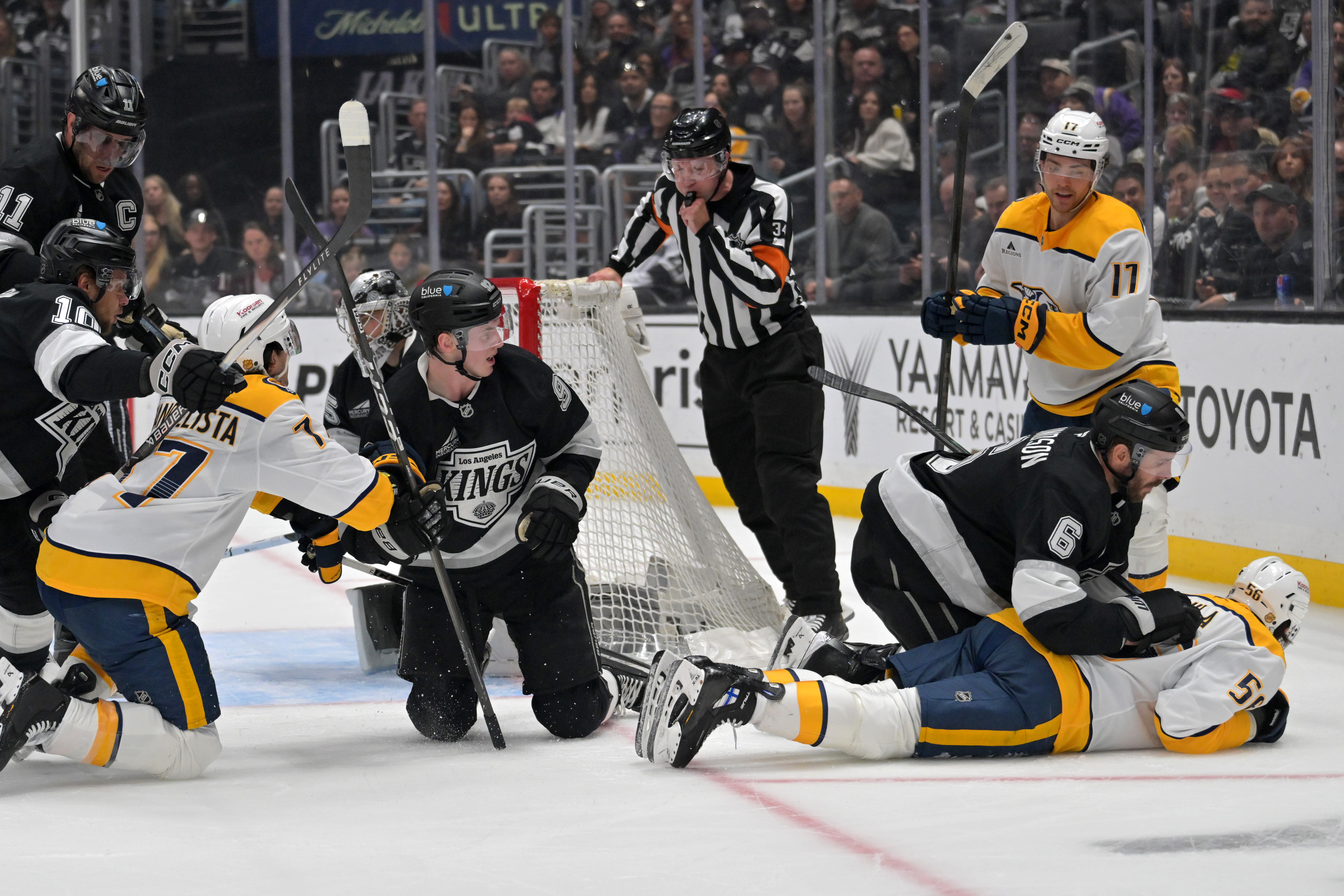 Referee Brandon Schrader (34) stops play as Kings defenseman Brandt...