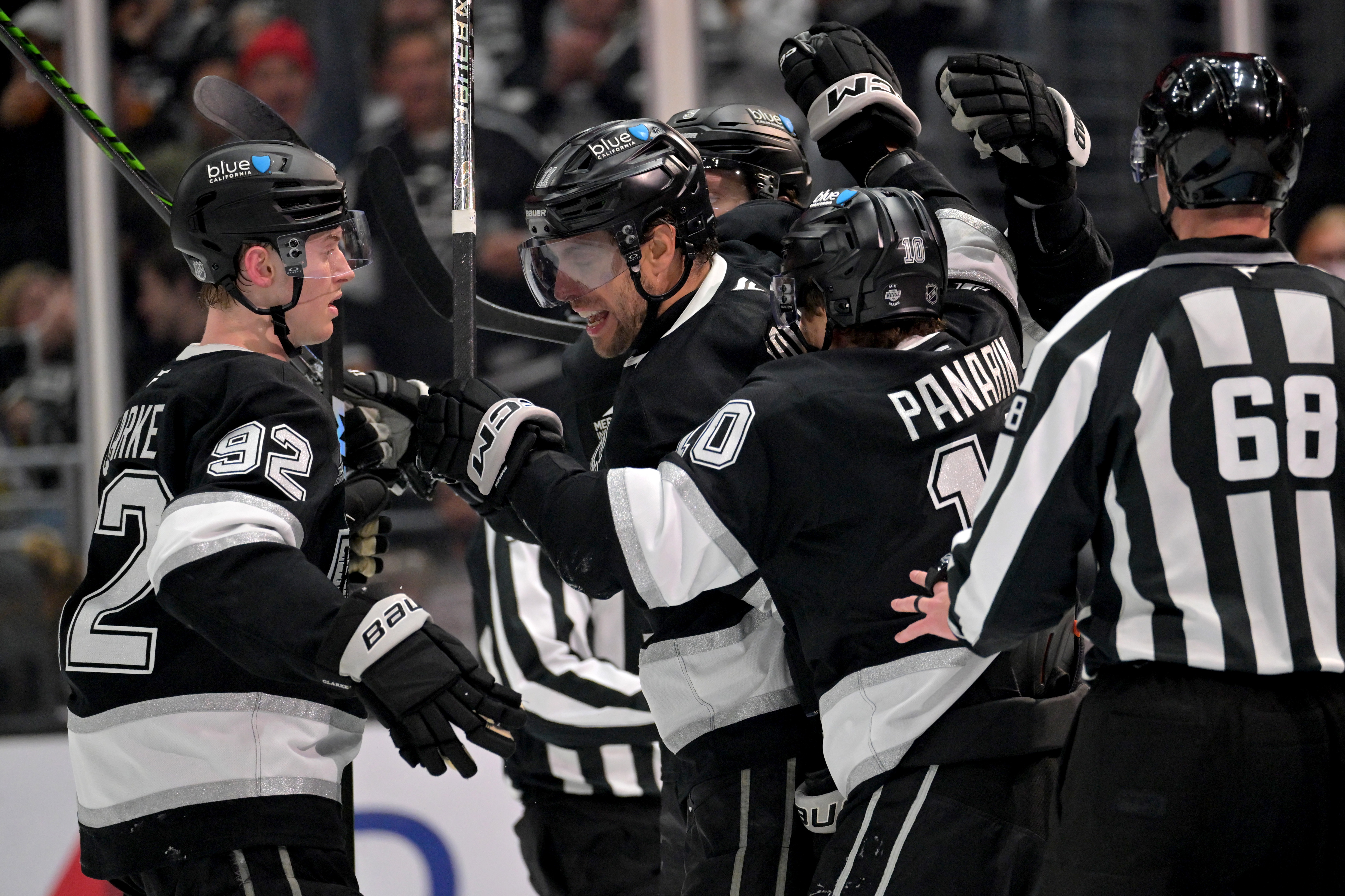 Kings defenseman Brandt Clarke, left, center Anze Kopitar and left...