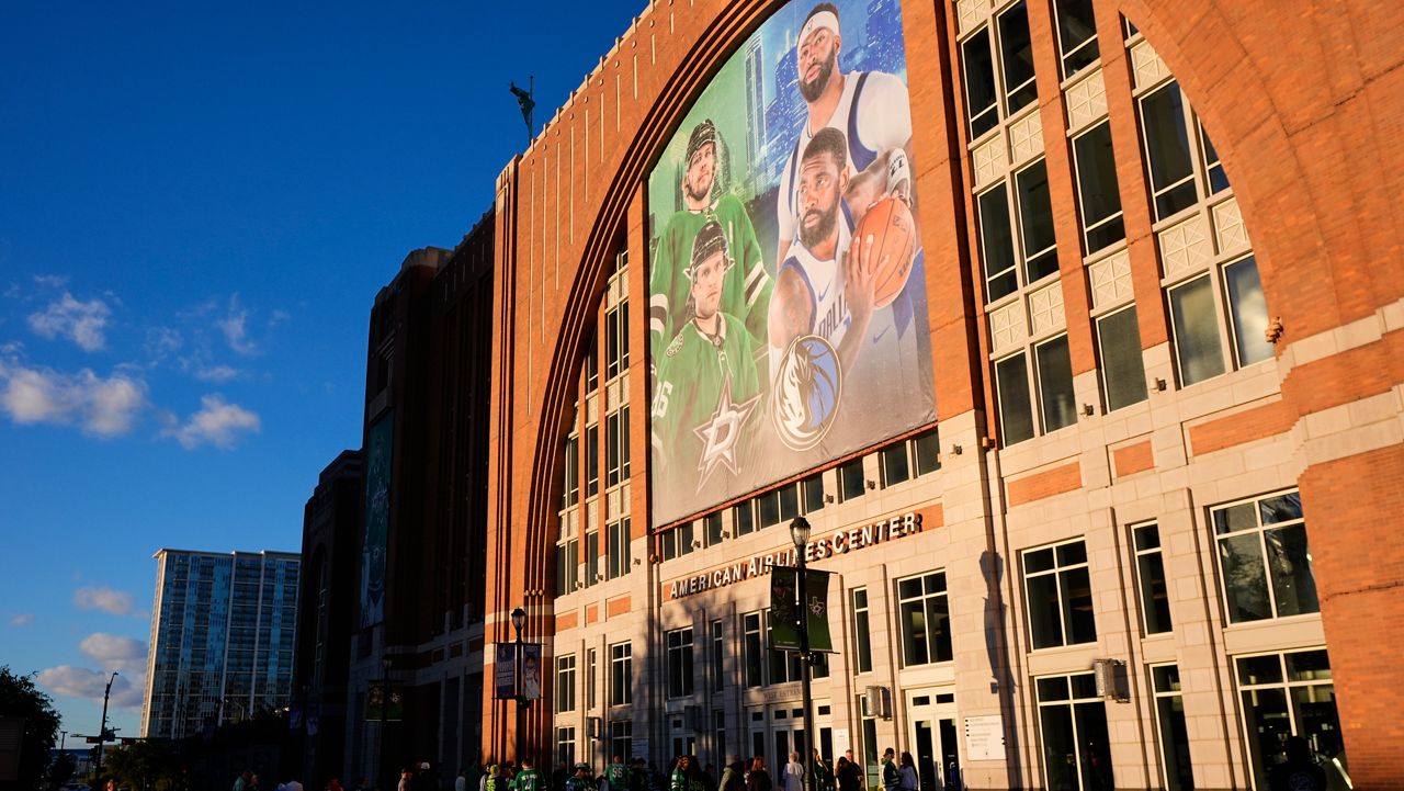 Fans line up outside the doors of American Airlines Center before the start of an NHL hockey game in Dallas, on Tuesday, Oct. 28, 2025. (AP Photo/Tony Gutierrez)