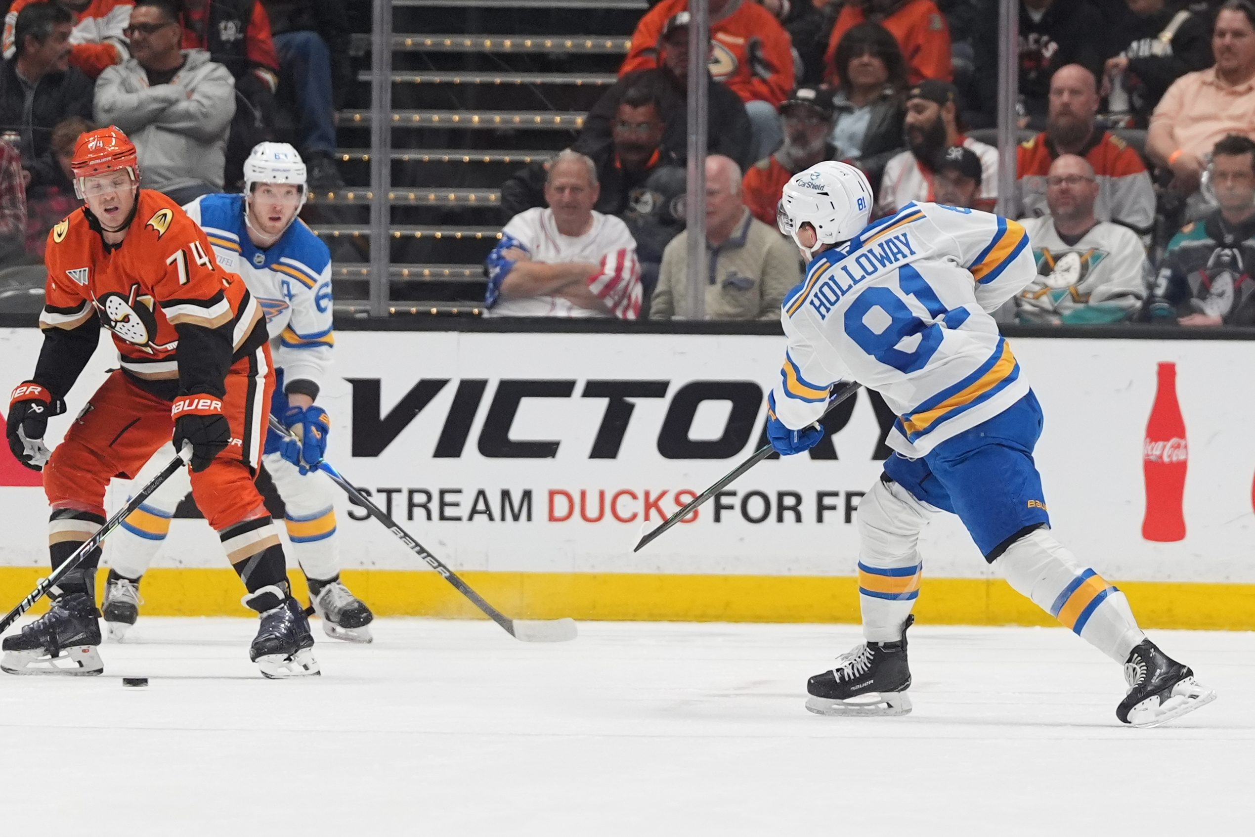 St. Louis Blues left wing Dylan Holloway, right, scores a...
