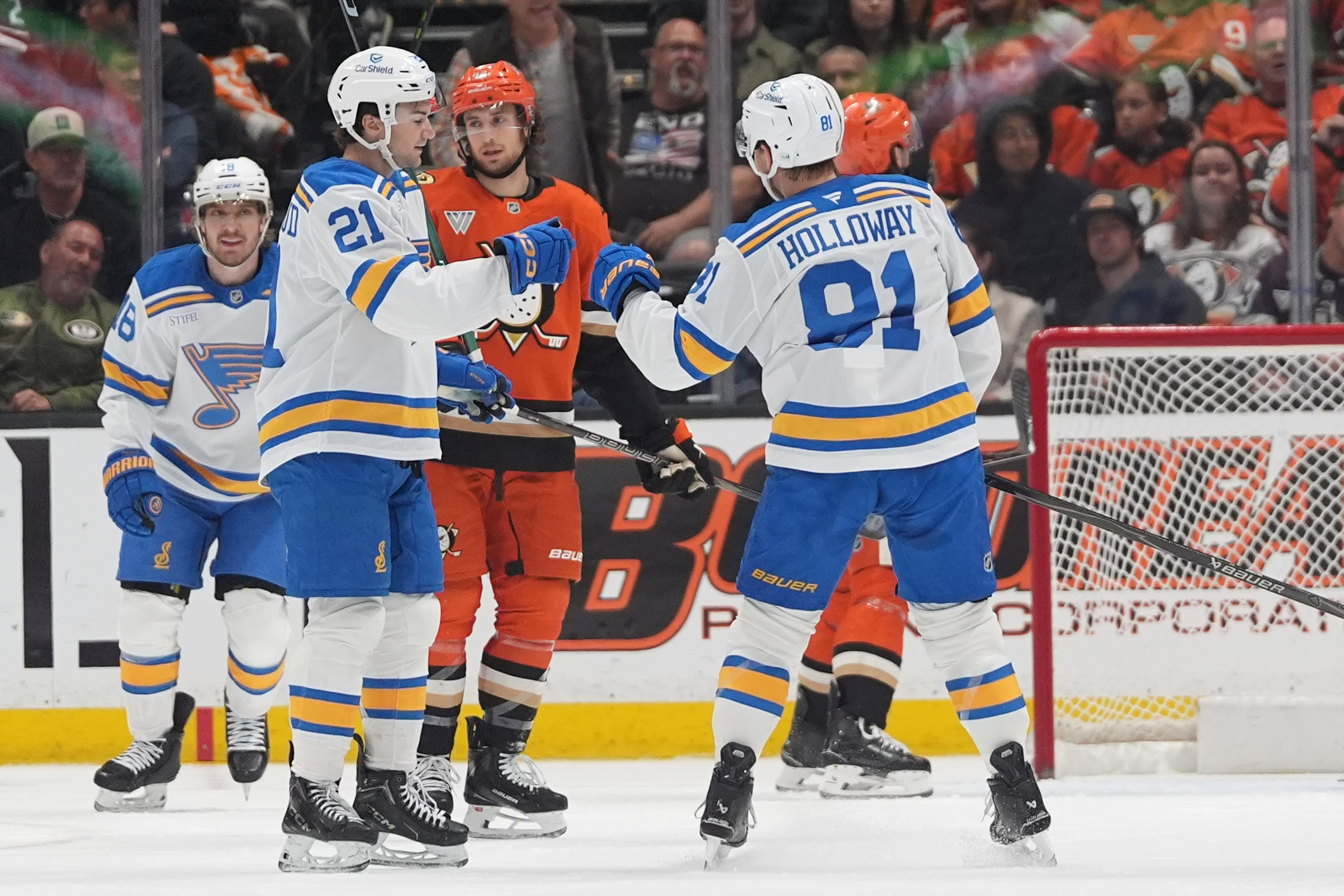 St. Louis Blues left wing Dylan Holloway, right, celebrates his...