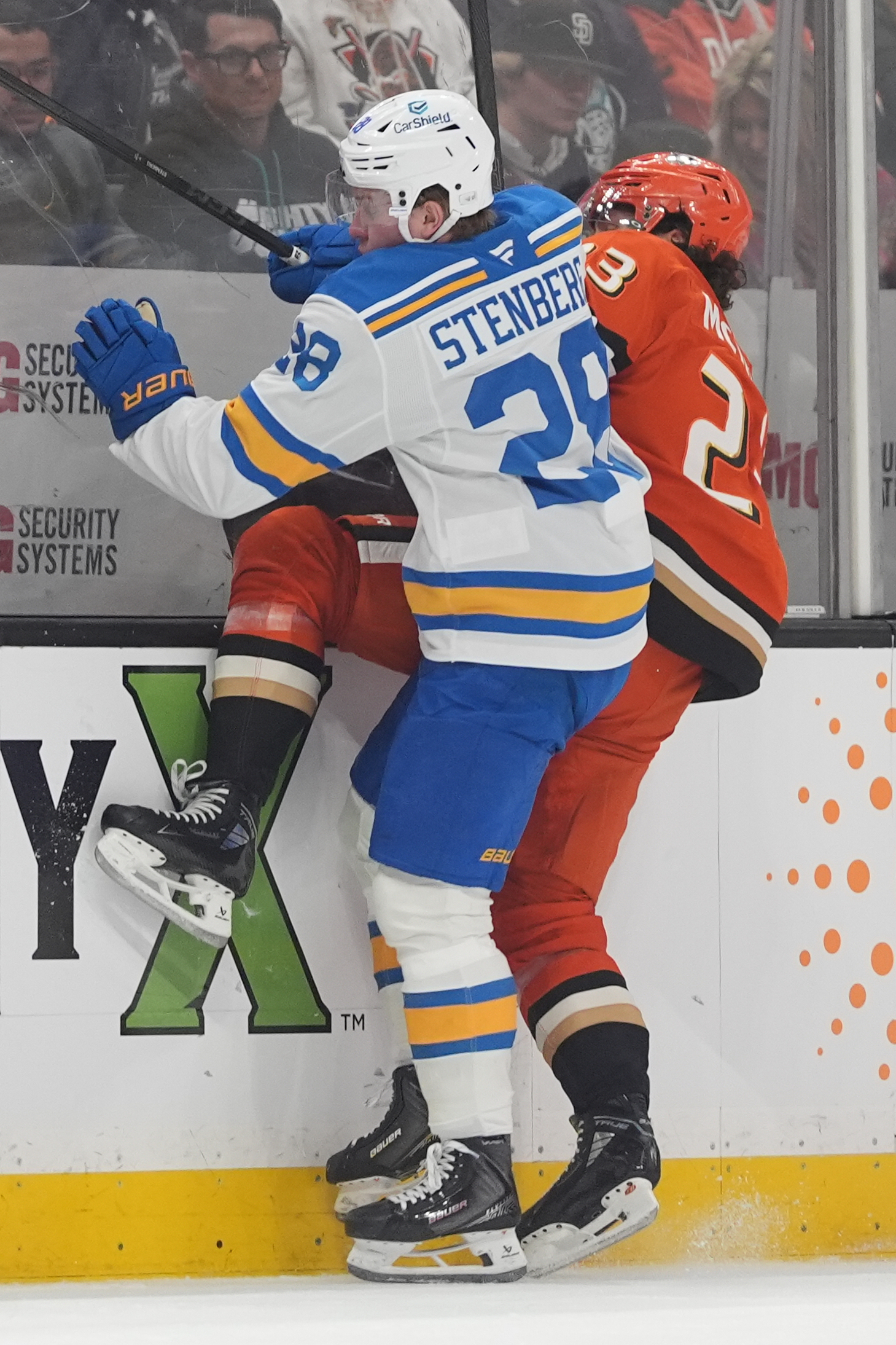 St. Louis Blues center Otto Stenberg, left, checks Ducks center...