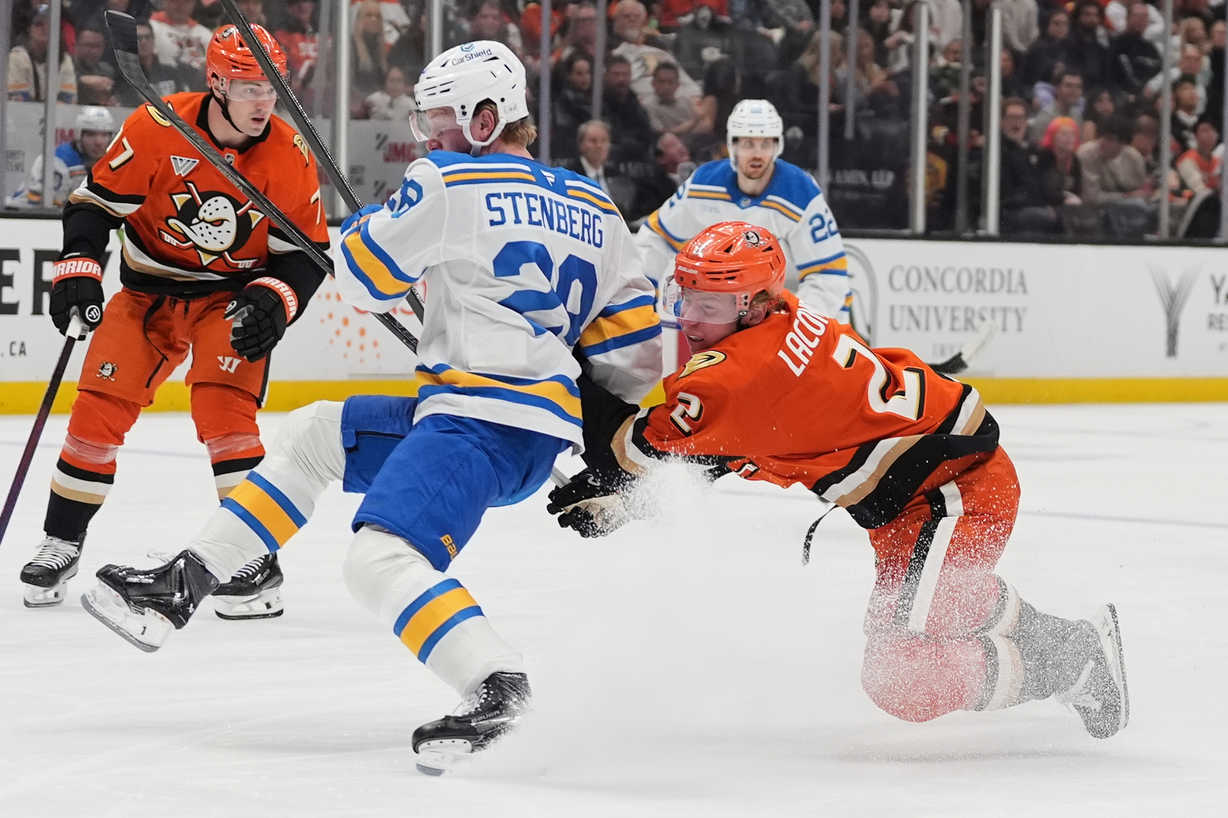 Ducks defenseman Jackson LaCombe, right, collides with St. Louis Blues...