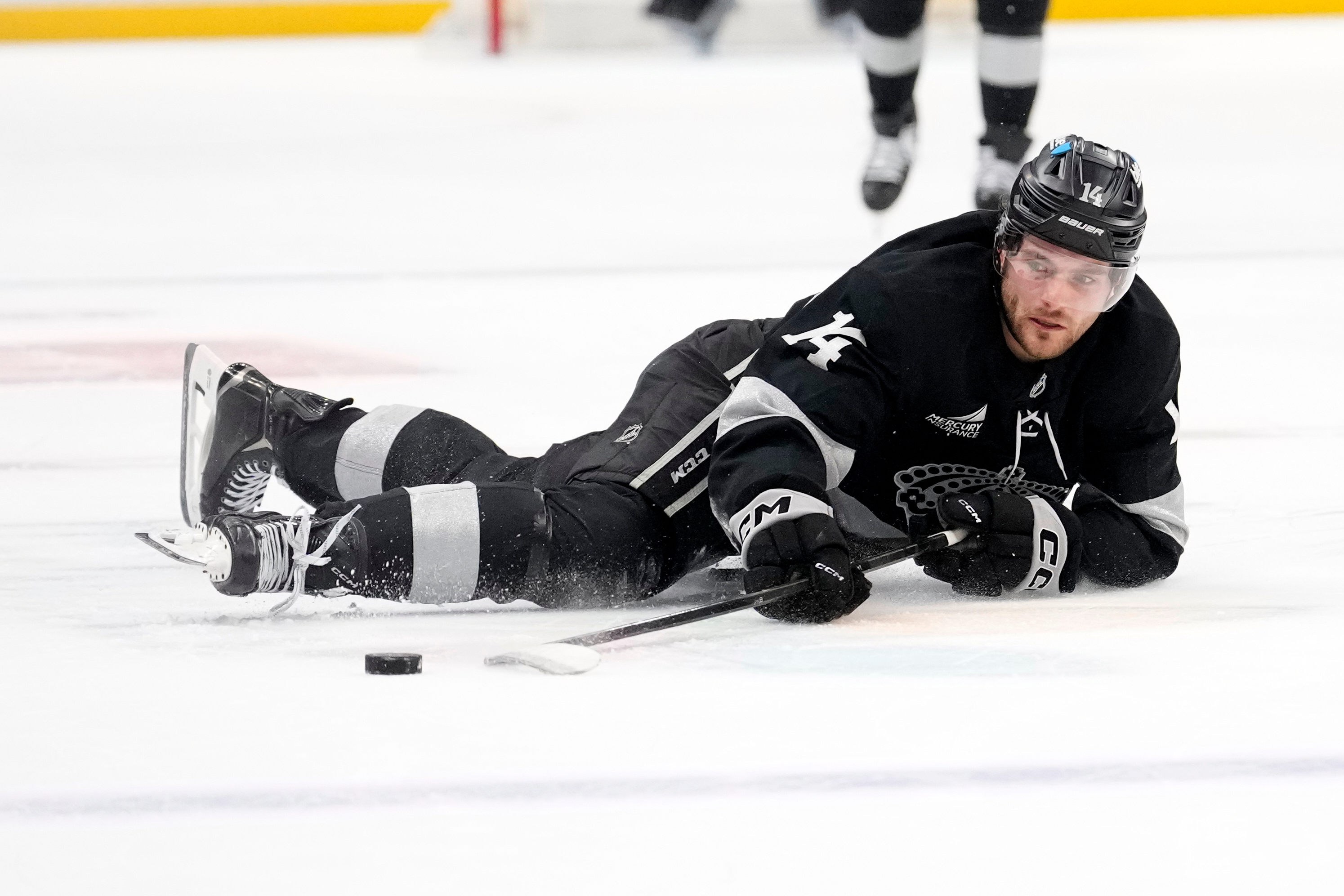 Kings right wing Alex Laferriere tries to pass the puck...