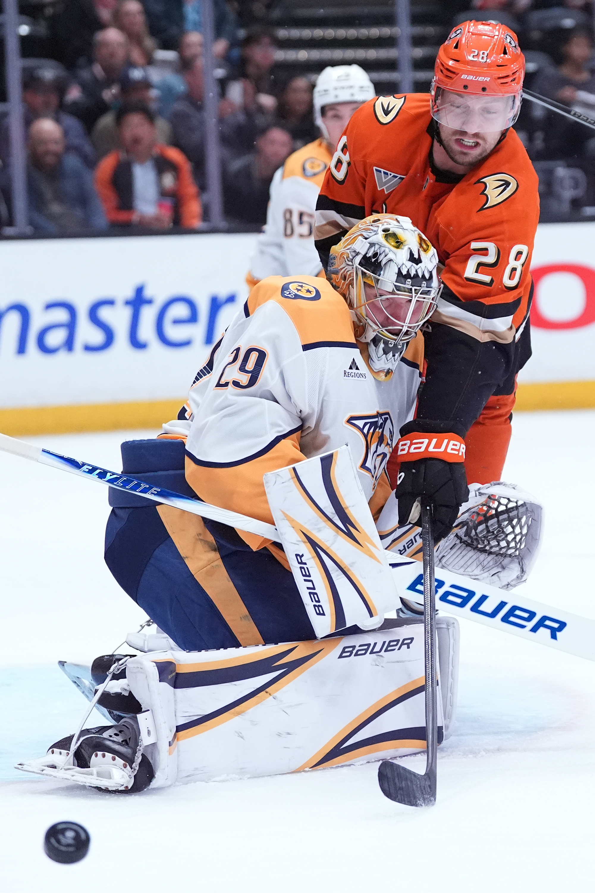 Nashville Predators goaltender Justus Annunen, left, makes a save against...