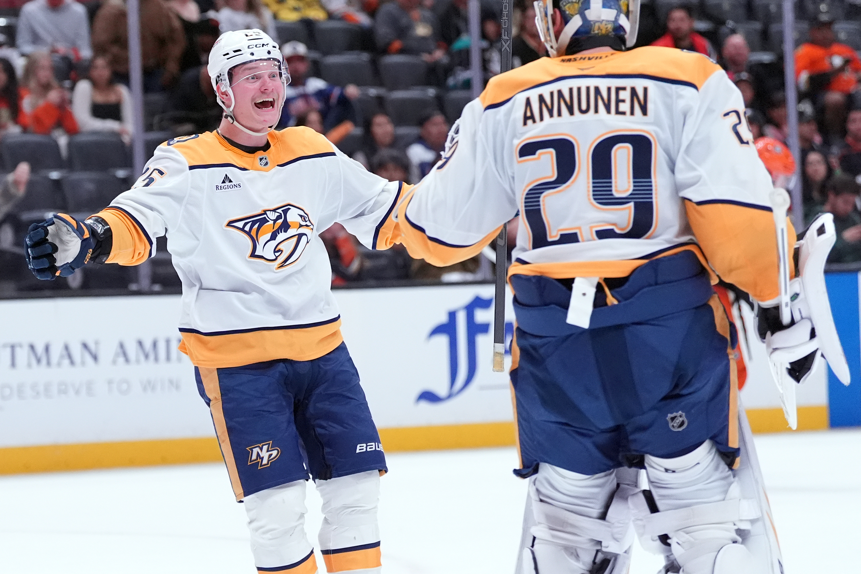Nashville Predators right wing Joakim Kemell, left, celebrates with goaltender...