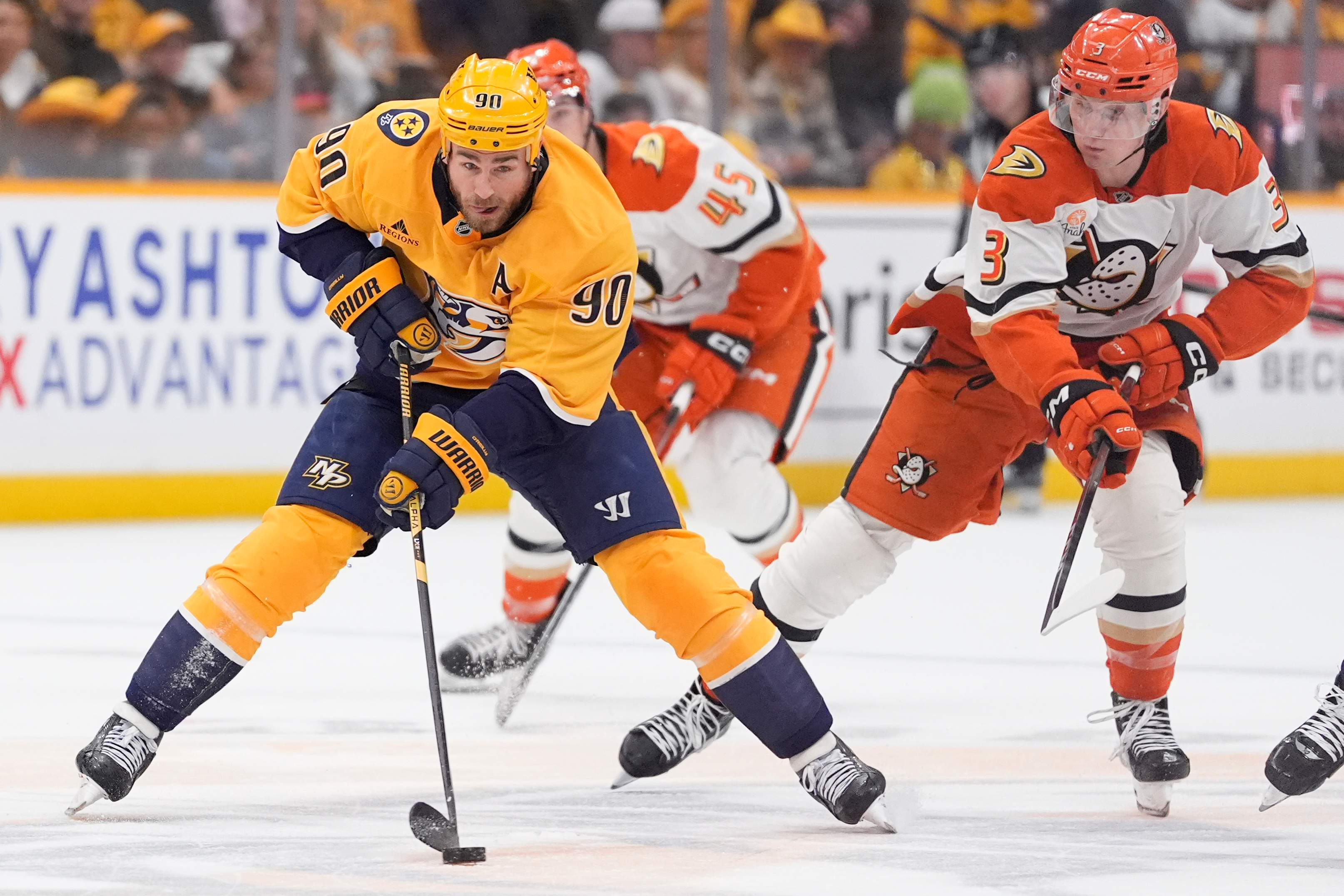 Nashville Predators center Ryan O’Reilly (90) skates the puck past...