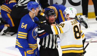 Buffalo Sabres defenseman Logan Stanley (64) and Boston Bruins left wing Tanner Jeannot (84) are separated