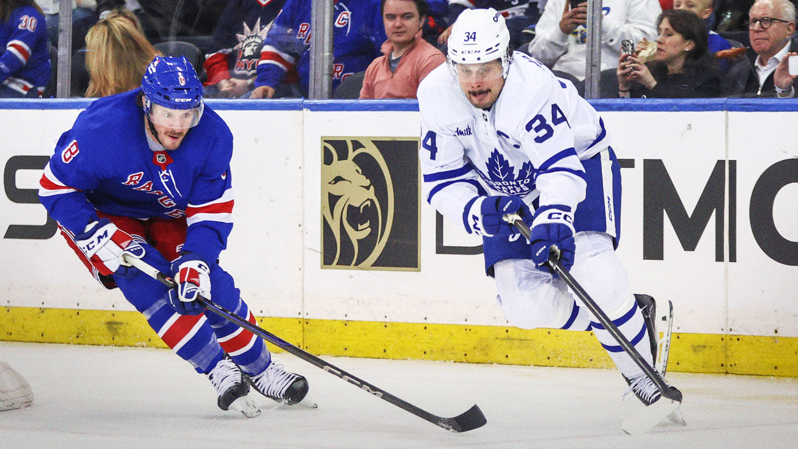 New York Rangers left wing J.T. Miller (8) and Toronto Maple Leafs center Auston Matthews (34) chase after the puck in the second period at Madison Square Garden.