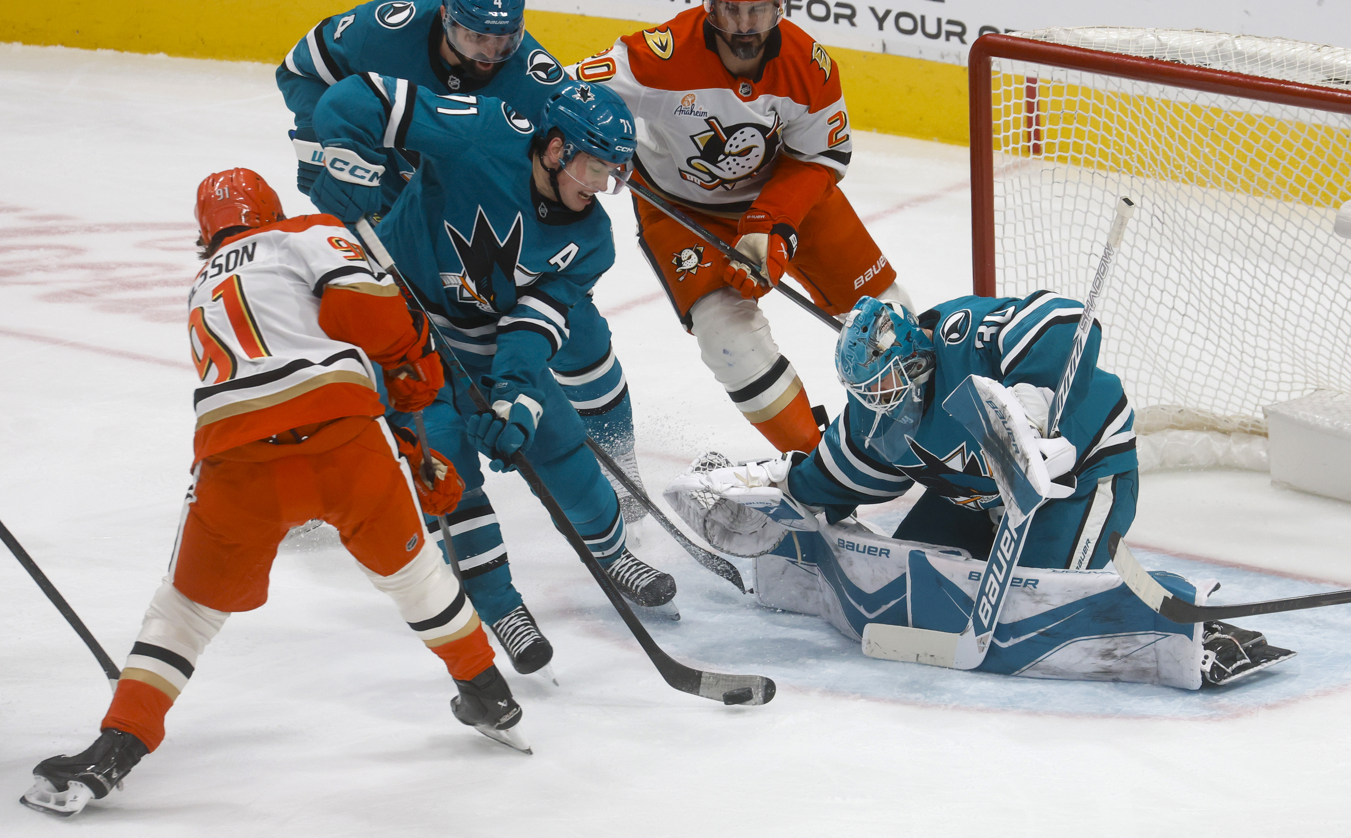 San Jose Sharks' Macklin Celebrini (71) clears the puck in...