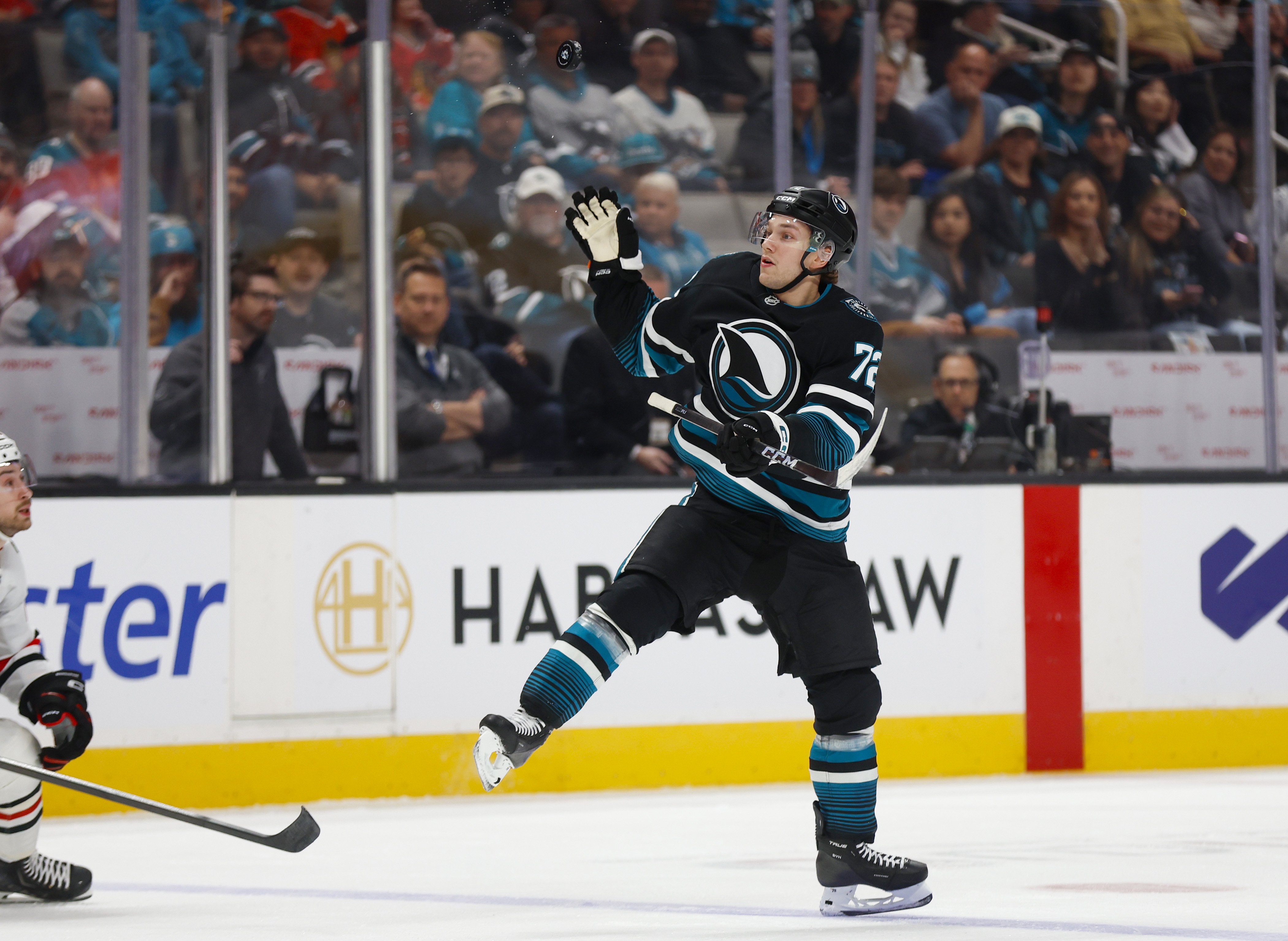 San Jose Sharks’ William Eklund (72) bats the puck down...