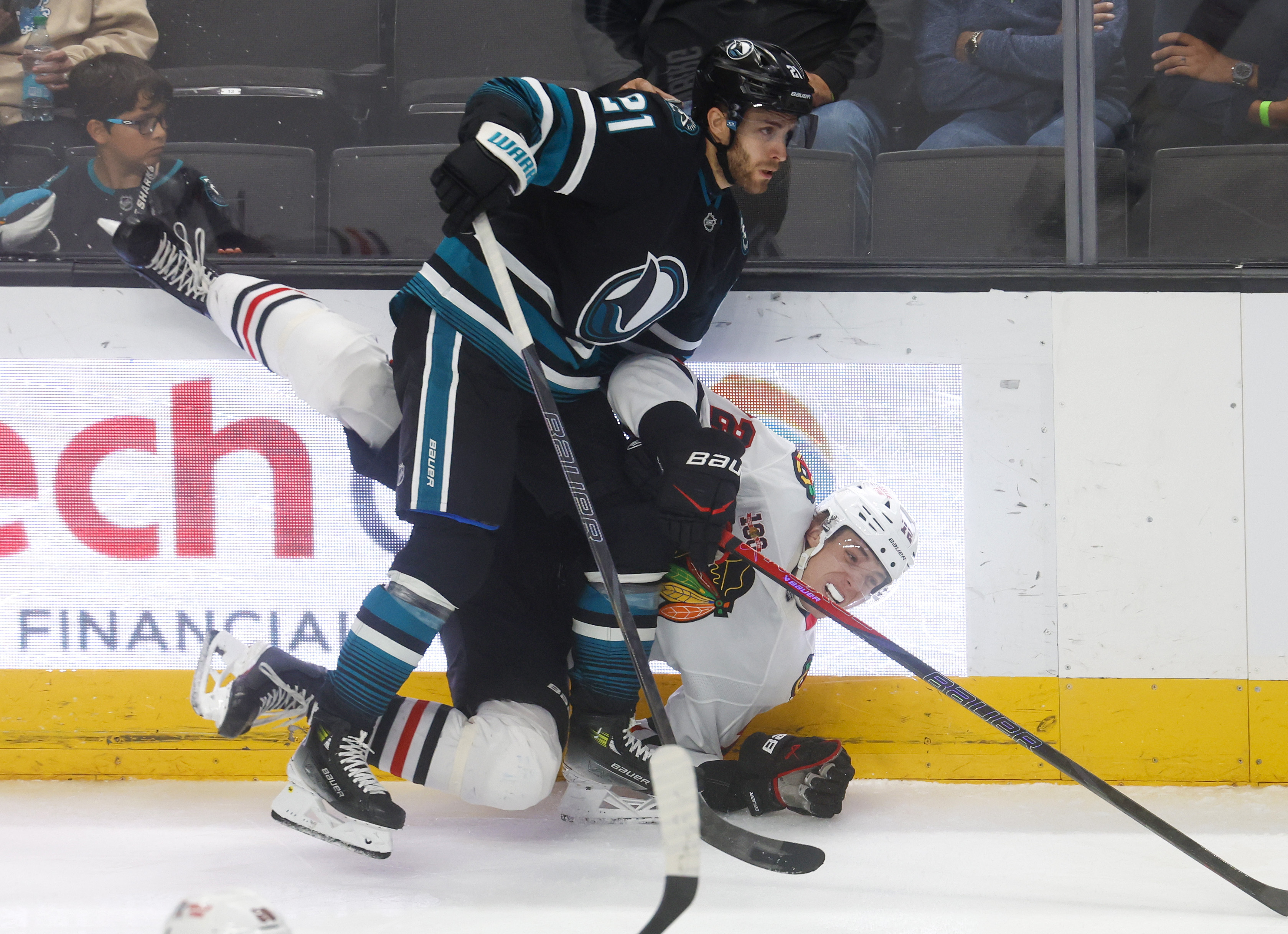 San Jose Sharks’ Alexander Wennberg (21) checks Chicago Blackhawks’ Alex...