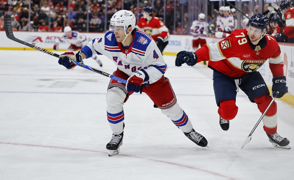 Braden Schneider (left) battles Cole Schwindt for the puck during the Rangers' loss to the Panthers on April 13, 2026.