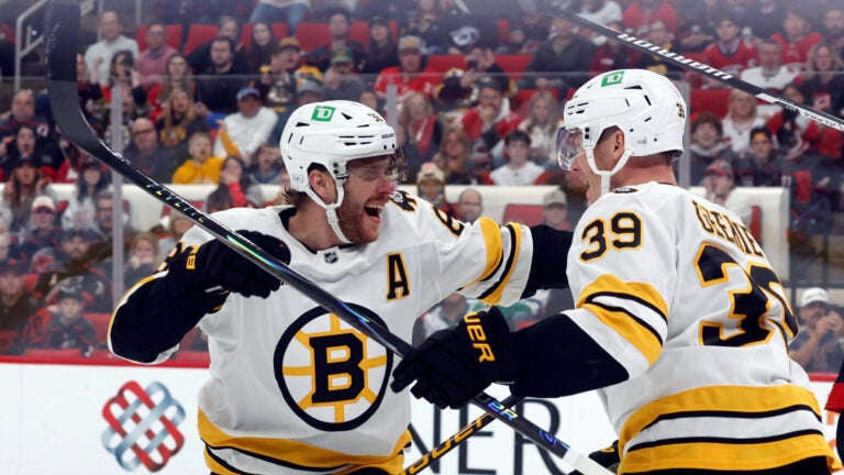 Boston Bruins' David Pastrnak (88) congratulates teammate Morgan Geekie (39) on his goal during the first period of an NHL hockey game against the Carolina Hurricanes in Raleigh, N.C., Tuesday, April 7, 2026.