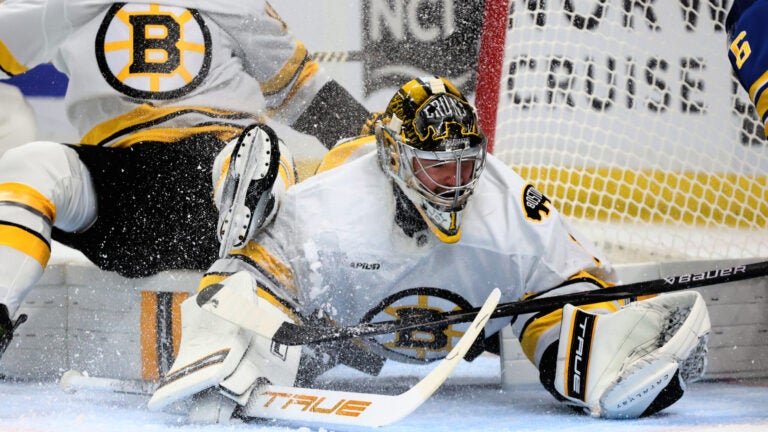 Boston Bruins goaltender Jeremy Swayman (1) makes a save in traffic during the first period in Game 2 of a first-round NHL hockey Stanley Cup playoff series against the Buffalo Sabres Tuesday, April 21, 2026, in Buffalo, N.Y.
