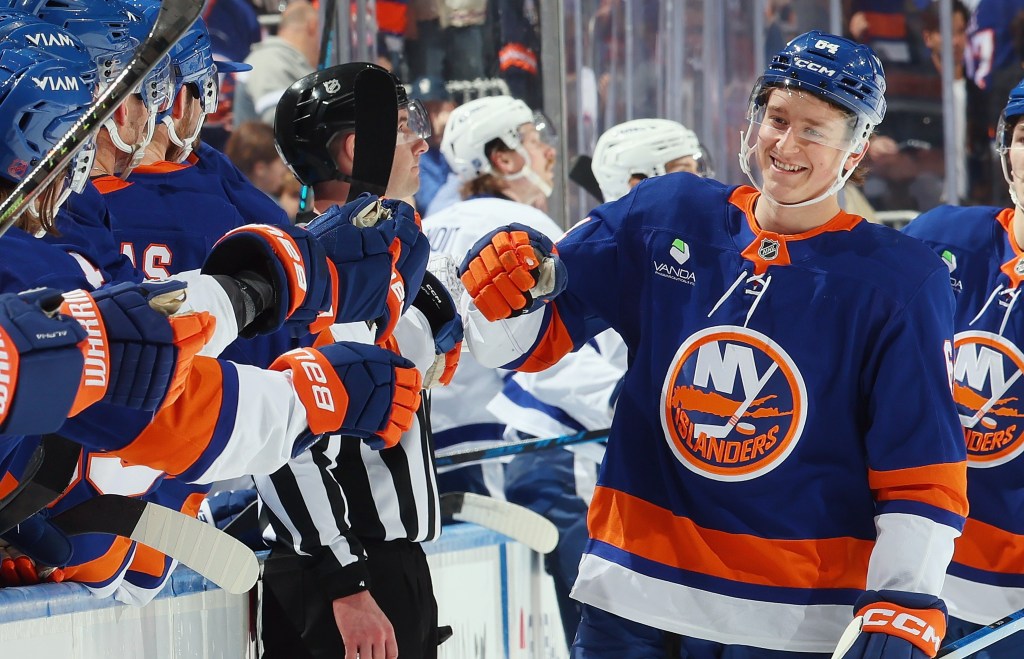 Cal Ritchie is all smiles as he celebrates with teammates after scoring a third-period goal in the Islanders' win over the Maple Leafs on April 9, 2026.