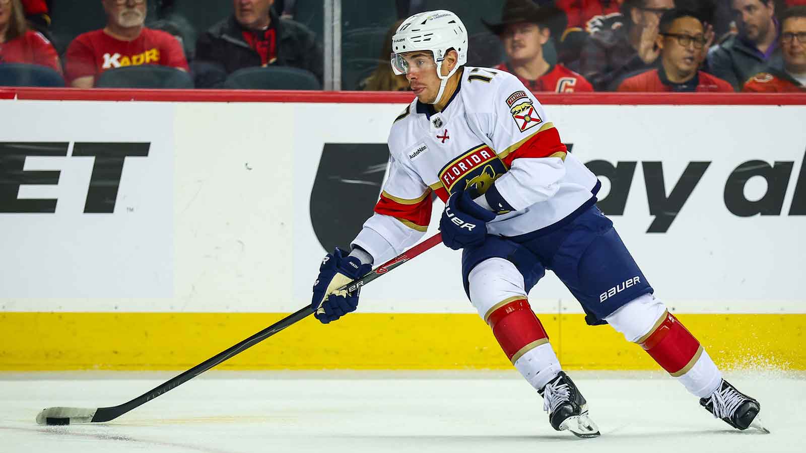 Florida Panthers center Evan Rodrigues (17) skates with the puck against the Calgary Flames during the first period at Scotiabank Saddledome.