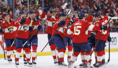 Brad Marchand celebrates 1k points with his teammates.