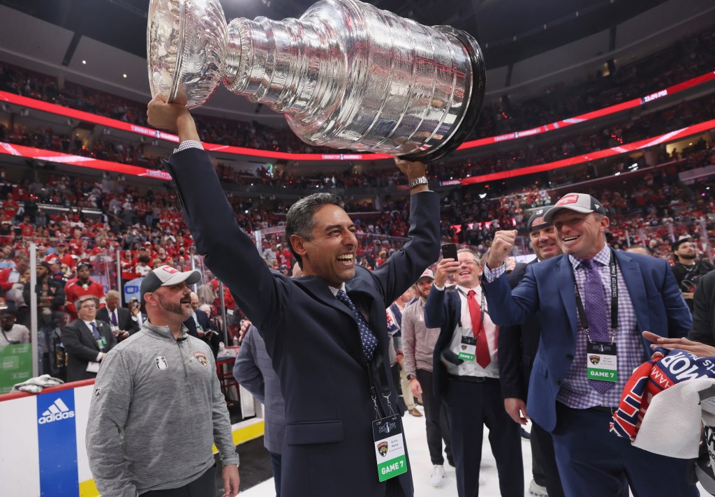 Florida Panthers owner Sunny Mehta raises the Stanley Cup trophy over his head after Game 7.