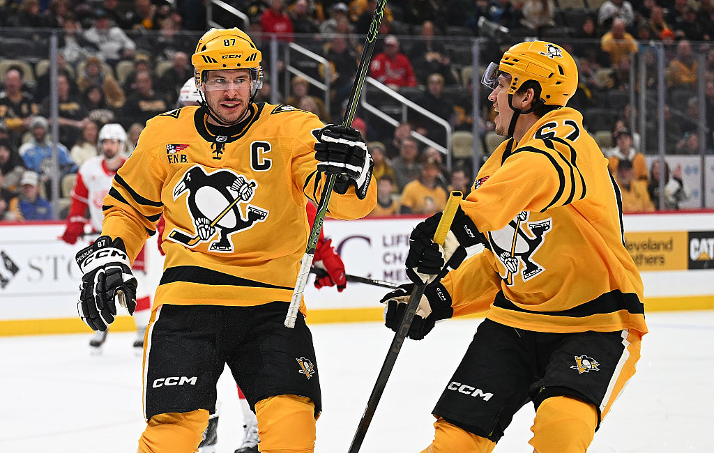 PITTSBURGH, PENNSYLVANIA - JANUARY 1: Sidney Crosby #87 of the Pittsburgh Penguins celebrates with Rickard Rakell #67 after scoring his second goal in the first period against the Detroit Red Wings at PPG PAINTS Arena on January 1, 2026 in Pittsburgh, Pennsylvania. (Photo by Justin Berl/Getty Images)