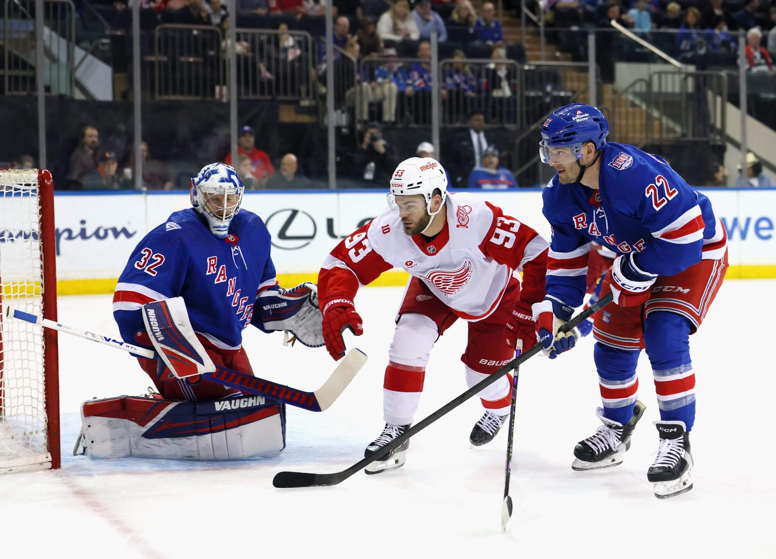 Alex DeBrincat of the Detroit Red Wings skates through a gap against the New York Rangers at Madison Square Garden.