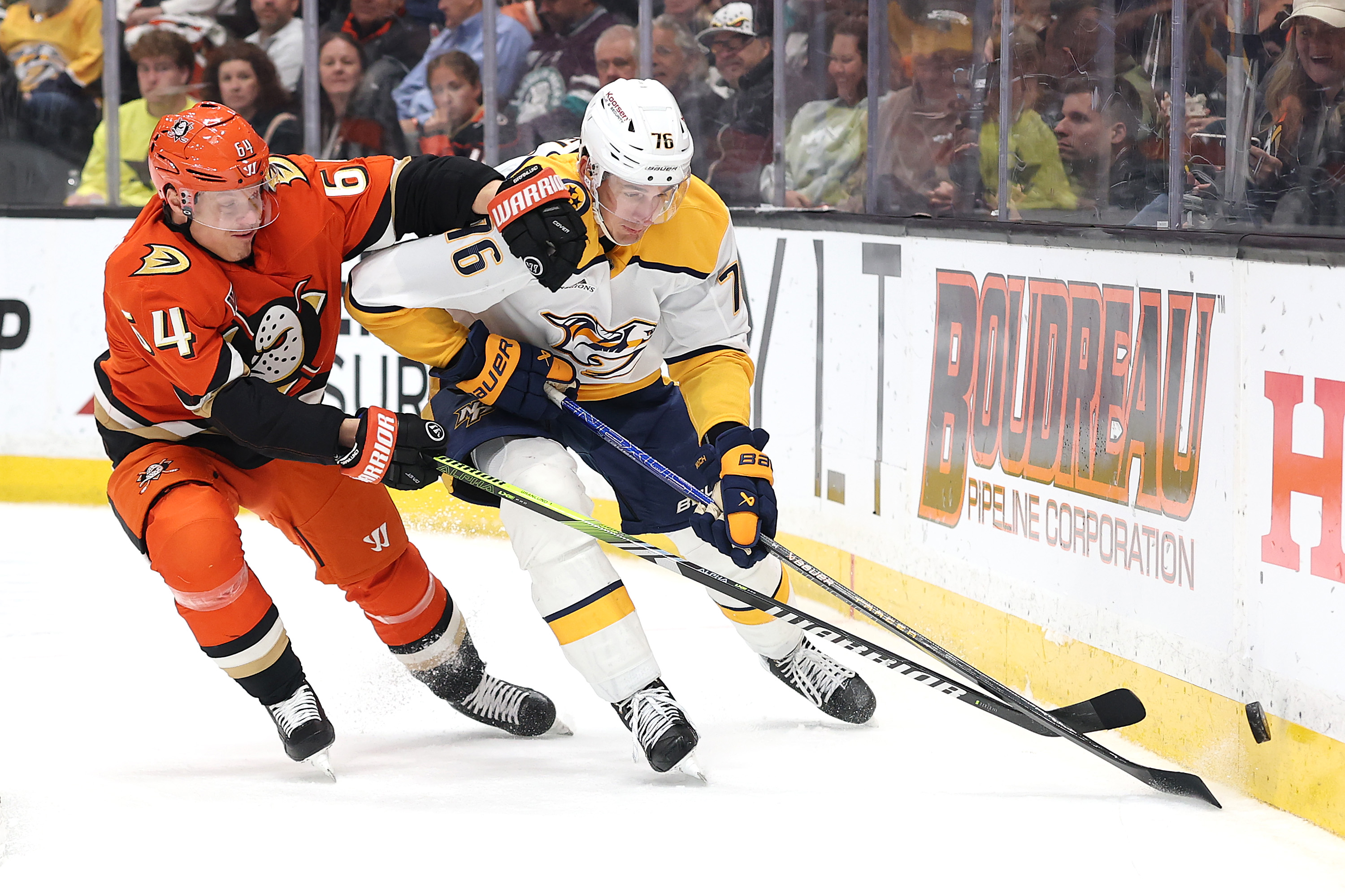 The Ducks’ Mikael Granlund, left, battles the Nashville Predators’ Brady...