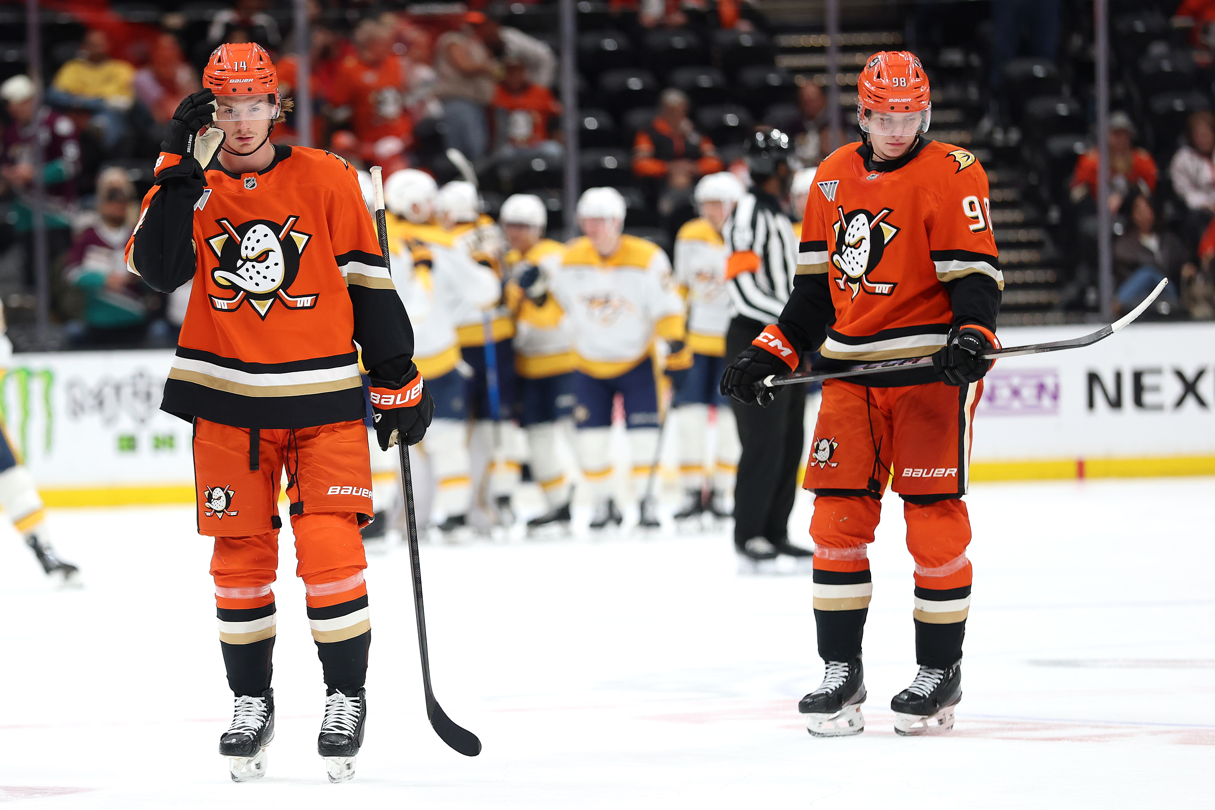 The Nashville Predators celebrate as the Ducks’ Drew Helleson, left,...