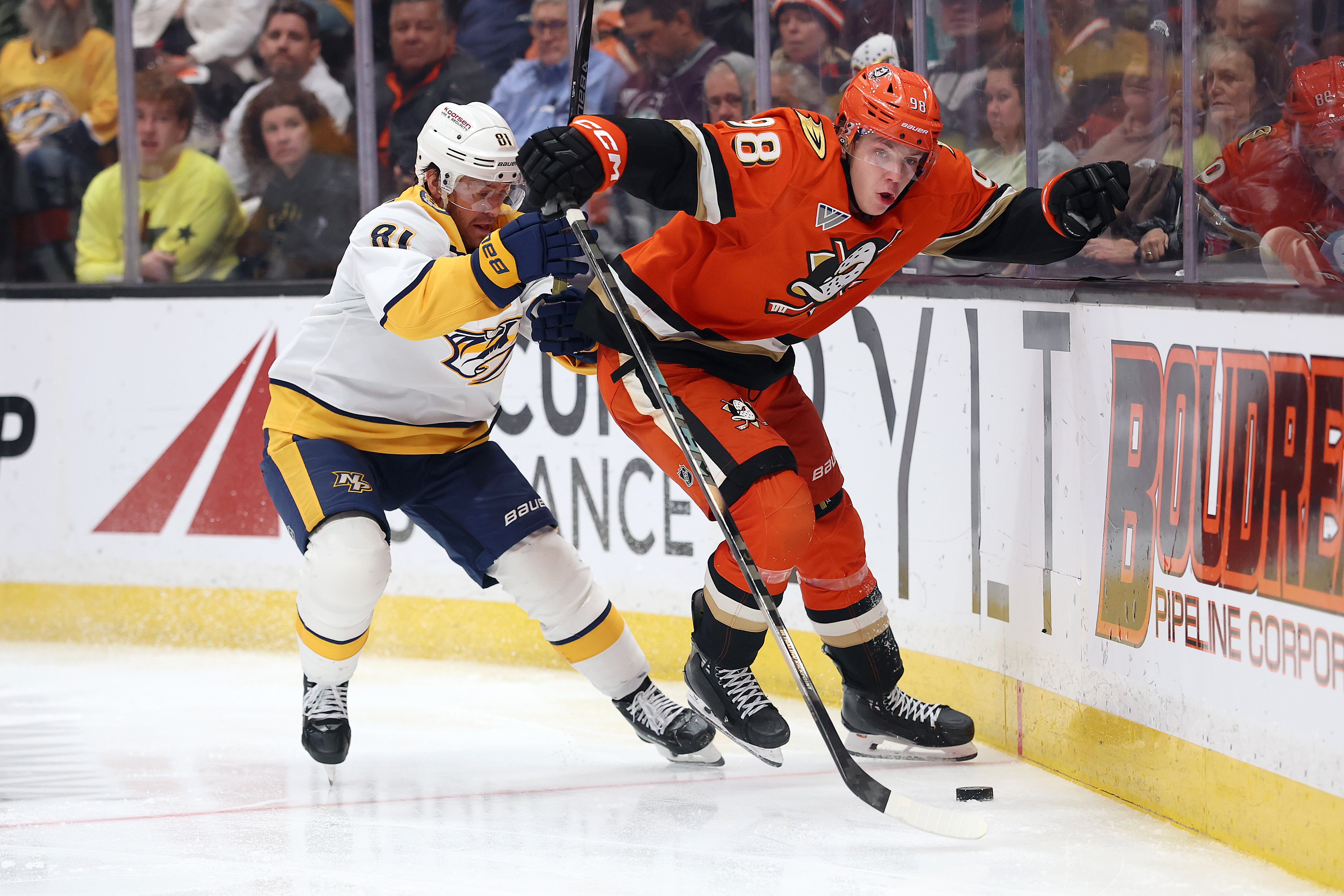The Nashville Predators’ Jonathan Marchessault, left, pushes the Ducks’ Pavel...